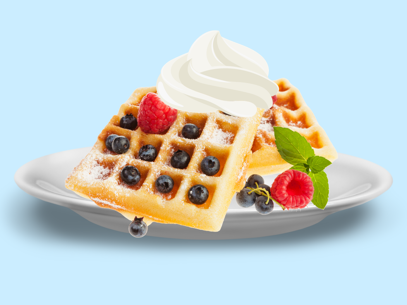 Picture of waffles with berries and whipped cream on top.